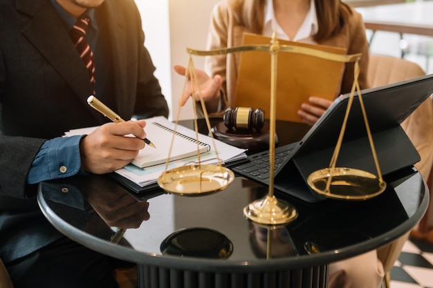 Business people and lawyers discussing contract papers sitting at the table Concepts of law advice legal services