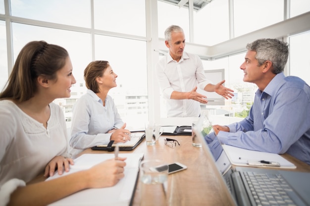 Business people listening to colleagues presentation