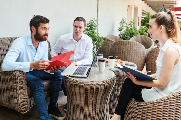 Business people listening to ideas on coworker