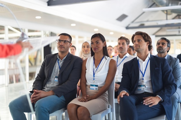 Business people listening to speaker in business seminar