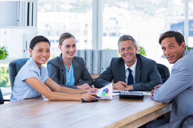 Business people looking at camera during meeting 