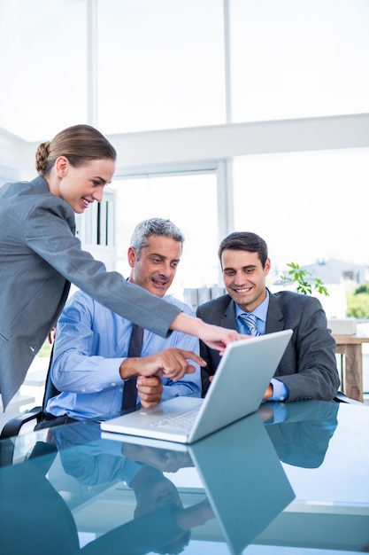 Business people looking at laptop computer 