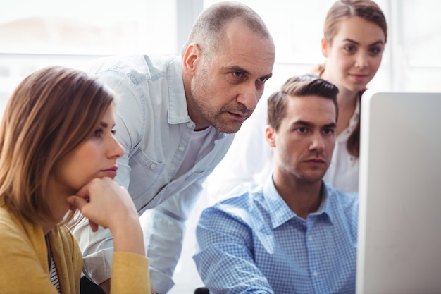 business people looking at laptop