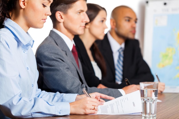 Business people making report at table with charts