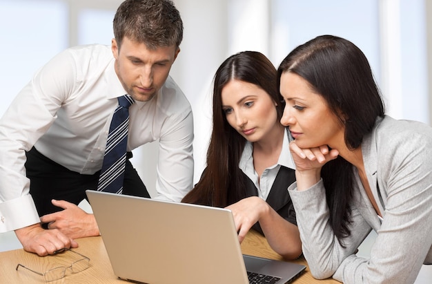 Business people making report at table with laptop on table