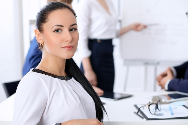 Business people at a meeting in the office. Focus on boss woman.