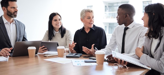 Photo business people meeting and professional team talking in a corporate office for brainstorming diversity men and women at a table for planning discussion and strategy with technology and ideas