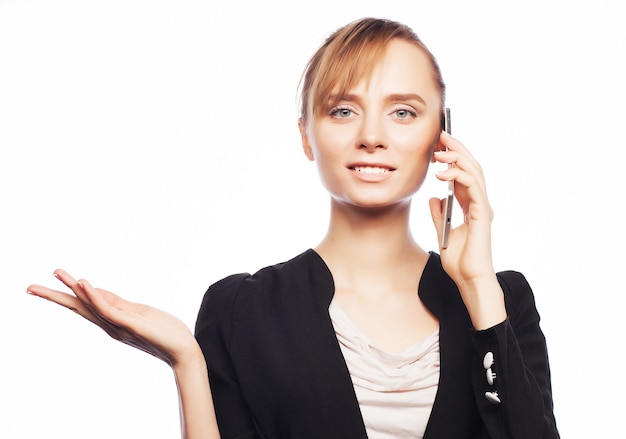 Business, people and office concept: young business woman with mobile phone. Positive emotion.Isolated on white.