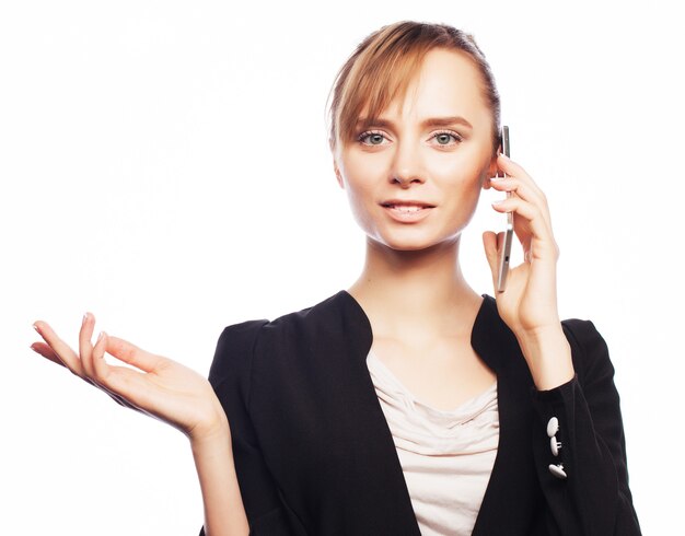 Business, people and office concept: young business woman with mobile phone. Positive emotion.Isolated on white.