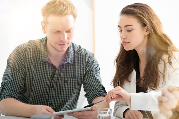 Business people in office connected on internet network with a tablet. concept of startup company