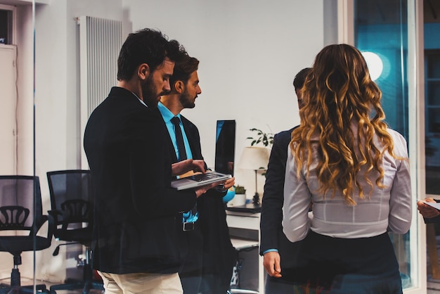 Business people in office work together during a meeting with laptop