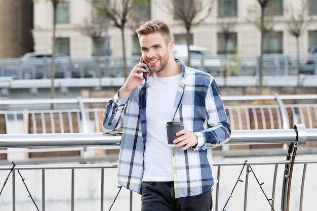 Business people office worker talking on smartphone talking on\
phone with cup of coffee student has coffee break coffee time and\
summer holiday vacation leisure communication and people\
concept