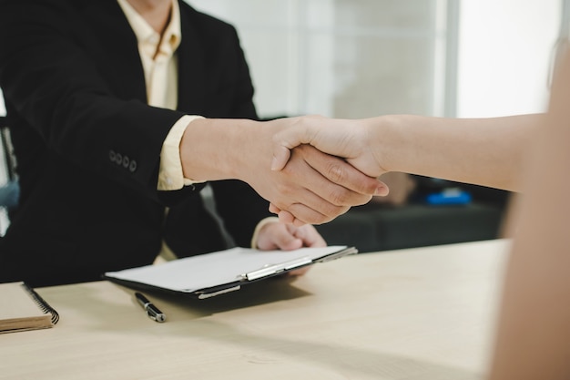 business people partner shaking hand after business signing contract desk in meeting room