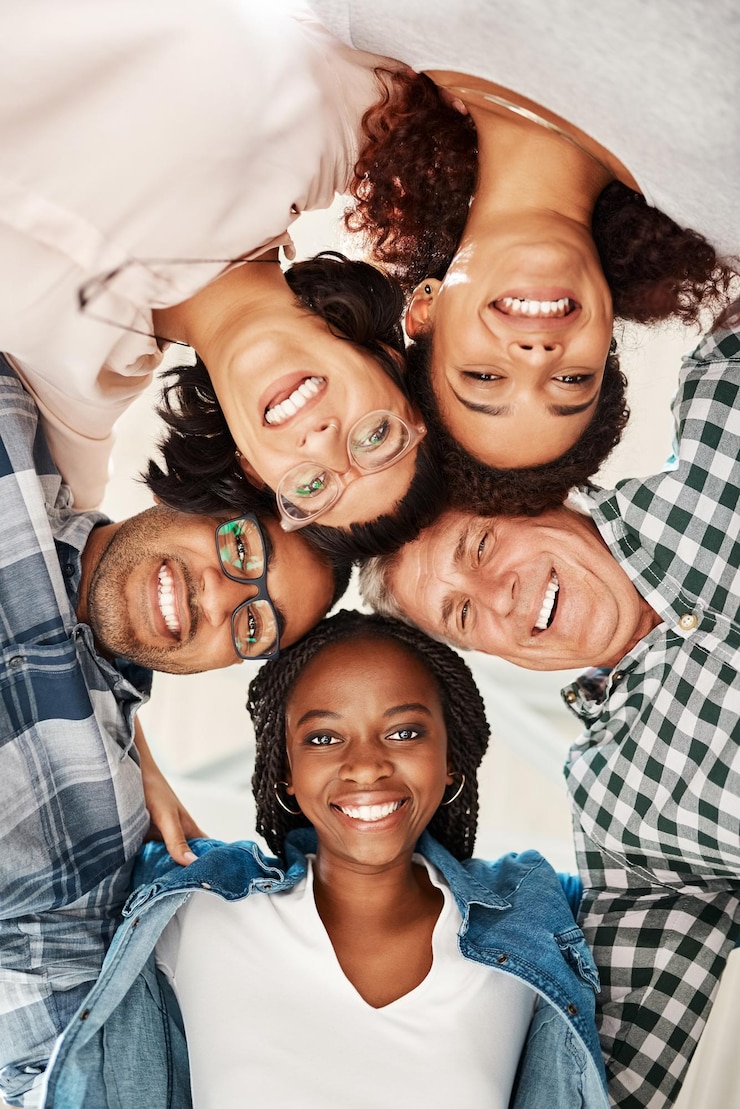 Photo business people portrait and smile in huddle with low angle teamwork and connection with diversity men woman and happy in scrum for hug with kindness synergy and link with solidarity at startup