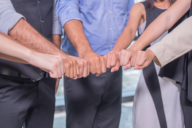 Business people putting their hands togetherStack of people handUnity and teamwork concept