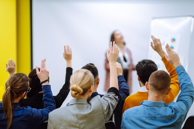 Business people raising hand up to ask question with
speaker