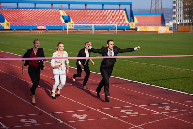 business people running together on racing track