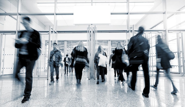 business people rushing in a entrance at a business center. ideal for websites and magazines layouts