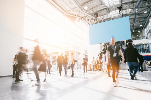 Photo business people rushing at a entrance at a trade show. ideal for websites and magazines layouts