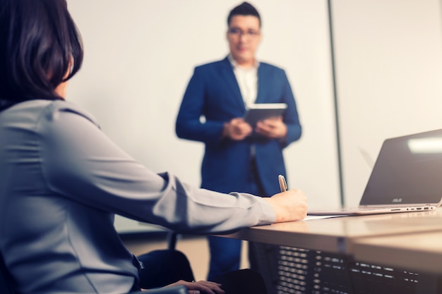 Business people in seminar room.