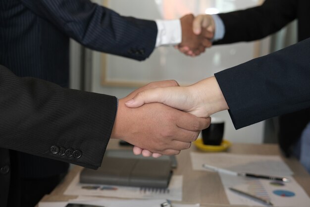 Business people shaking hands after finishing up meeting