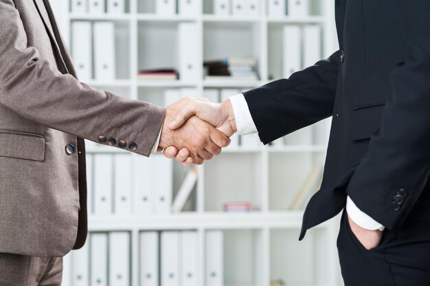 Business people shaking hands closeup