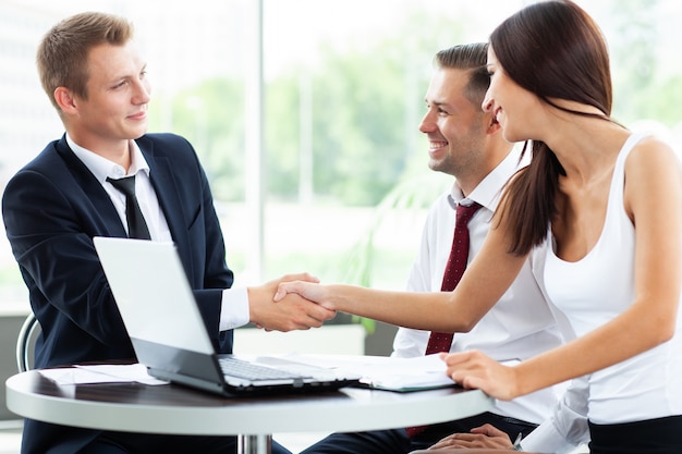 Business people shaking hands, finishing up a meeting.