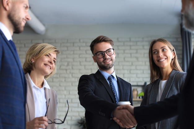 Business people shaking hands, finishing up a meeting.