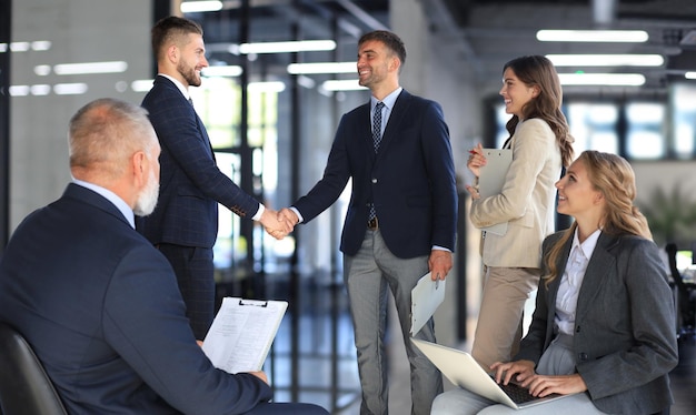 Photo business people shaking hands finishing up a meeting