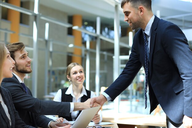 Business people shaking hands, finishing up a meeting.