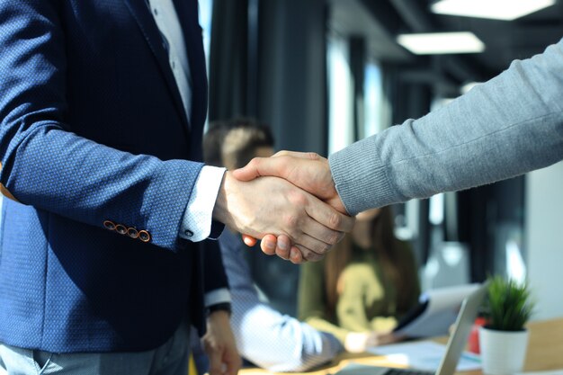 Photo business people shaking hands, finishing up a meeting