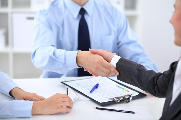 Business people shaking hands, finishing up a meeting.