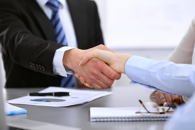 Business people shaking hands, finishing up a meeting.