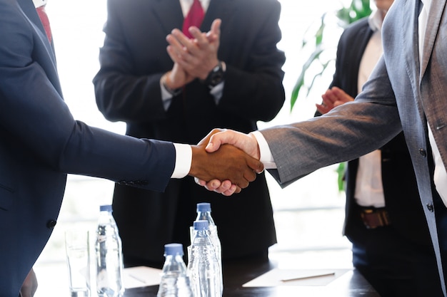 Business people shaking hands, finishing up meeting