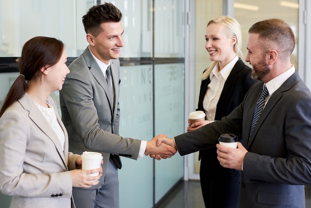 Business People Shaking Hands in Hall