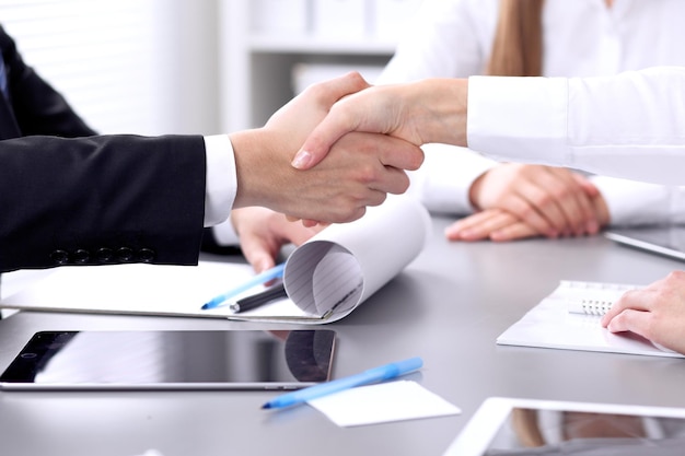 Business people shaking hands at meeting. Clouse up of handshake.