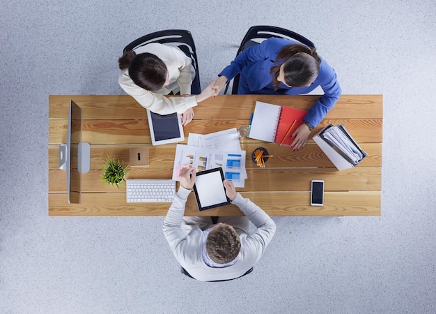 Business people shaking hands during meeting in office