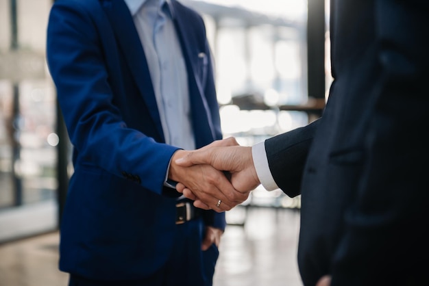 Business people shaking hands during a meeting Two happy mature business men xAxA