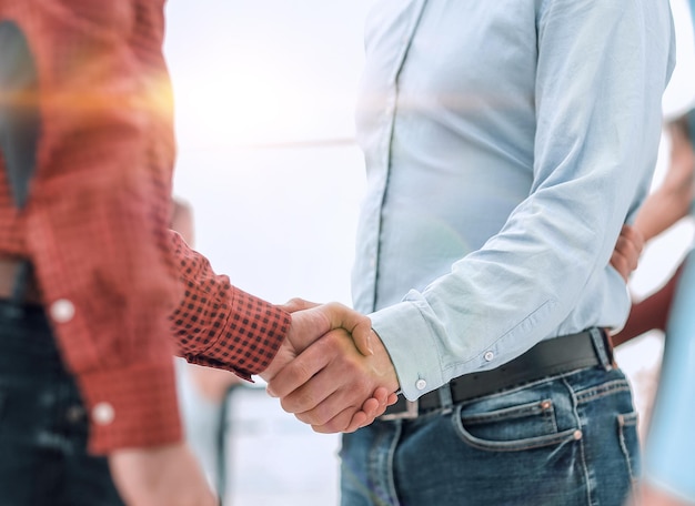 Business people shaking hands in modern conference office.