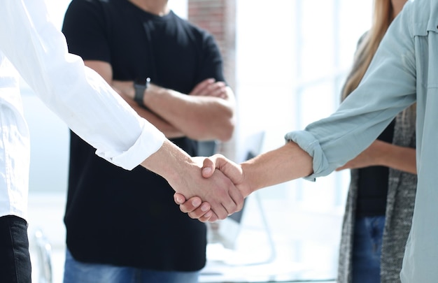 Business people shaking hands in the office after successful meeting