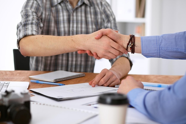 Business people shaking hands in office of hipster interiors