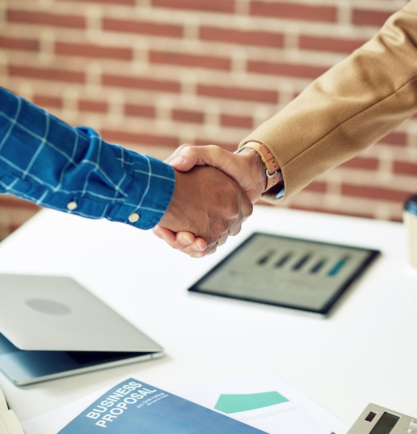 Business people shaking hands in office meeting after successful partnership deal for startup company