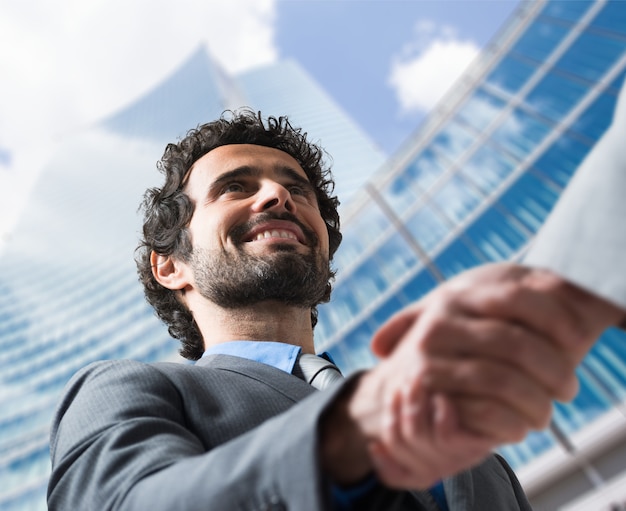 Business people shaking hands outdoors