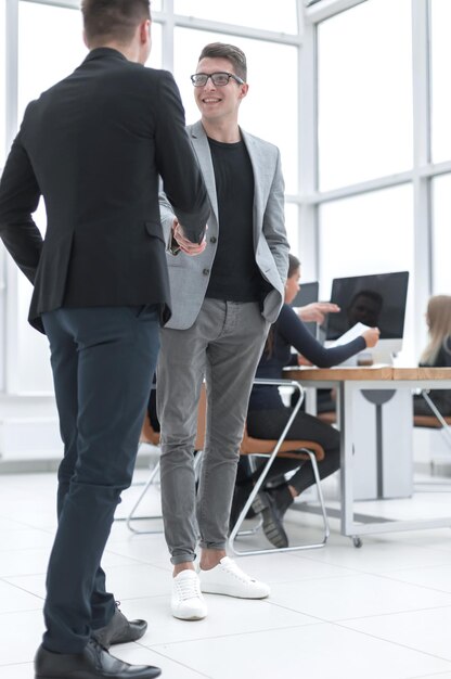 Business people shaking hands standing in the office