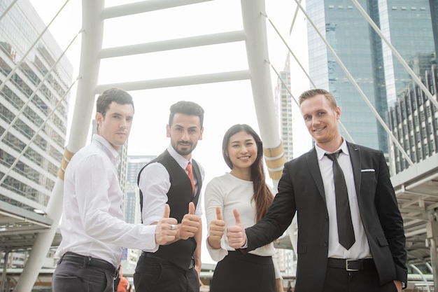 Business people show thumbs up and happy