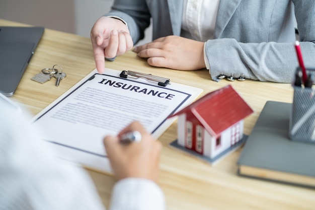 Business people signing contract making deal with real estate agent Concept for consultant home insurancexAReal estate investment Property insurance security Real estate agent offer house
