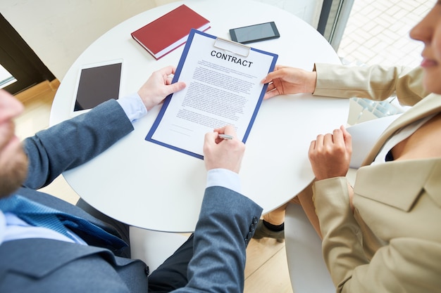 Business People Signing Contract Above View