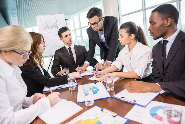 Business people sitting in conference room and working.