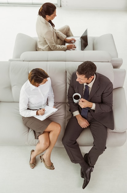 Business people sitting on couch
