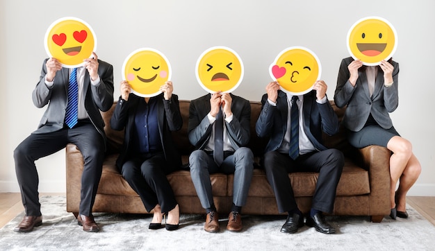 Business people sitting together with icons